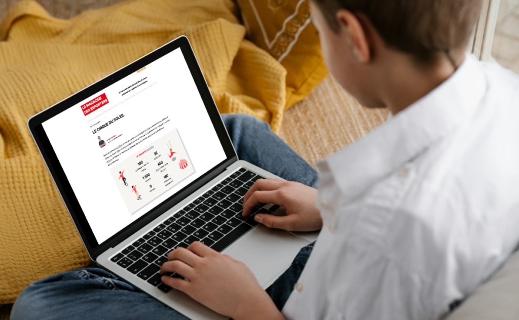 A young boy using a laptop to work in the KWL Canada Hub Online Platforms